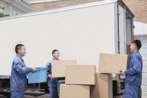Moving team beginning an East Finchley removals job with packed boxes