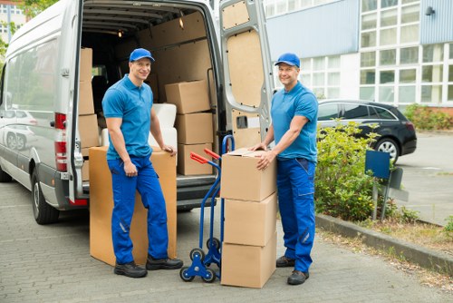 Mover handling furniture carefully during a scheduled removals service